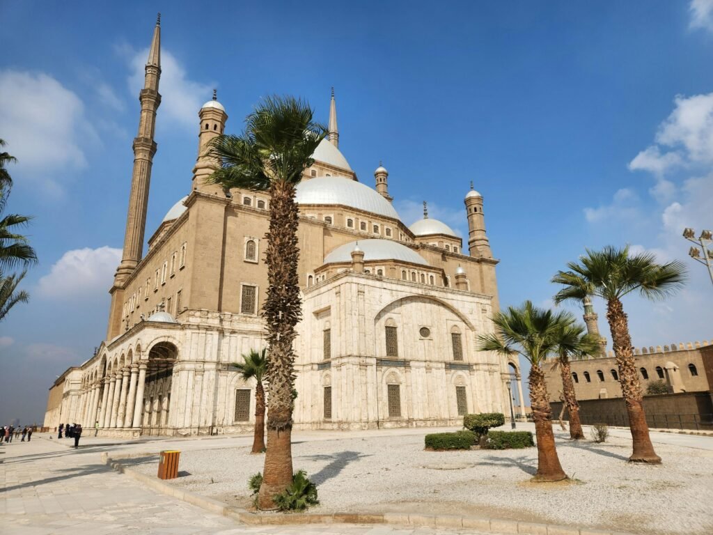 The stunning Alabaster Mosque in Cairo against a bright blue sky, showcasing historic Islamic architecture.